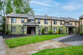 St. Helens apartment for rent - a row of houses with a sidewalk and grass