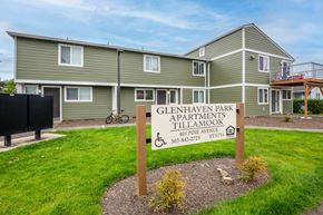 Tillamook apartment for rent - a sign in the grass in front of a building