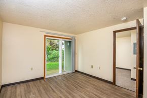 Tillamook apartment for rent - the living room of an empty house with a door to the backyard
