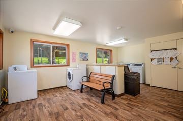 Lincoln City apartment for rent - a room with a bench and washer and dryer in it and a kitchen