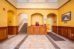 The Dalles apartment for rent - the lobby of a building with yellow walls and a staircase