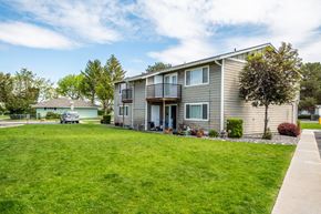 Boardman apartment for rent - a gray house with a green lawn in front of it