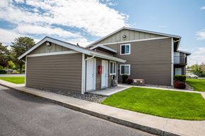 Boardman apartment for rent - the front of a house with a green lawn and a driveway