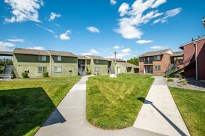 Hermiston apartment for rent - a row of houses on a sidewalk with grass