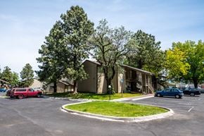 Milton-Freewater apartment for rent - a parking lot with cars parked in front of houses