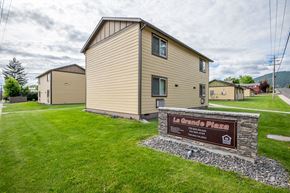 La Grande apartment for rent - a house with a sign in front of it on a grass field