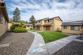 La Grande apartment for rent - a pathway between a row of houses with grass and a sidewalk