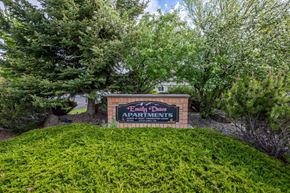 Island City apartment for rent - a sign for sandy dunes apartments in front of trees