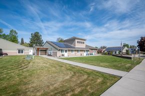 Baker City apartment for rent - a house with solar panels on the roof and a sidewalk