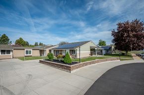 Baker City apartment for rent - a street with a row of houses with solar panels on the roofs
