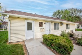 Ontario apartment for rent - a small yellow house with a white door and a sidewalk