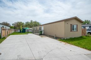 Ontario apartment for rent - a beige house with a driveway and a fence
