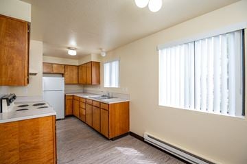 Fruitland apartment for rent - the preserve at ballantyne commons apartment kitchen with white appliances and wooden cabinets