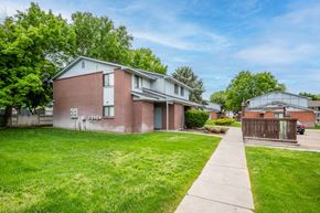 Fruitland apartment for rent - a brick house with a yard and a sidewalk
