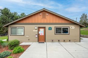 Madras apartment for rent - the front of a tan building with a sidewalk and a door