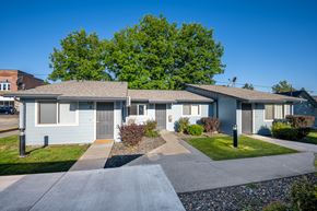 Wallowa apartment for rent - A row of houses with a tree in the background.
