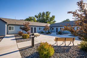 Wallowa apartment for rent - A sunny day at a park with benches and trees.
