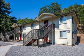 White Salmon apartment for rent - A two-story house with a red door and a balcony.
