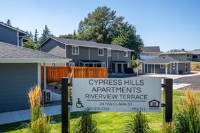Cascade Locks apartment for rent - A sign for Cypress Hills Apartments stands in front of a building.