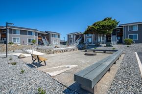 Gold Beach apartment for rent - A sunny day at a residential area with a playground and benches.