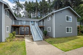 Lincoln City apartment for rent - A grey house with a staircase leading to the second floor.