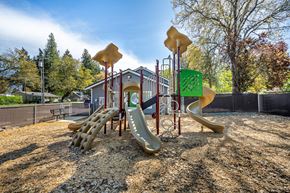 Veneta apartment for rent - A playground with a yellow slide and a green sign.