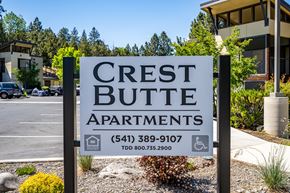 Bend apartment for rent - A sign for Crest Butte Apartments is displayed in front of a building.
