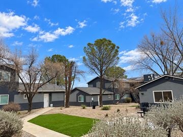 Cottonwood apartment for rent - A grey house with a green lawn and trees.