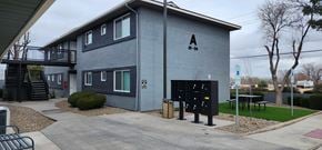 Chino Valley apartment for rent - A grey building with a black sign on the front.