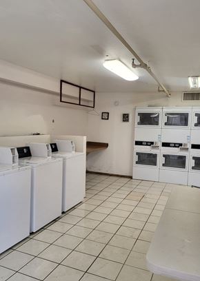 Coolidge apartment for rent - A laundry room with washers and dryers.