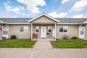 Elgin apartment for rent - A house with a red chair in front of it.