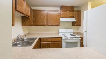 Ashland apartment for rent - a kitchen with a sink stove and refrigerator