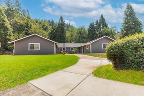 Canyonville apartment for rent - a gray house with a sidewalk in front of it