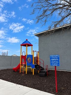 Chino Valley apartment for rent - A playground with a slide and a safety sign.
