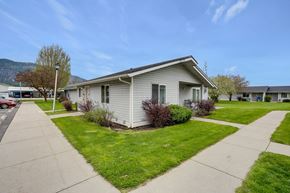 Chewelah apartment for rent - a white house with a sidewalk in front of it