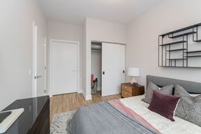 Chicago apartment for rent - a bedroom with a large bed and a mirrored closet