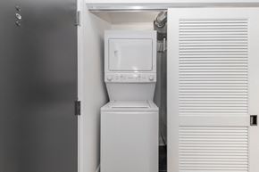 Chicago apartment for rent - a small laundry room with a washer and dryer