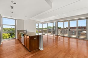 Des Plaines apartment for rent - a living room with a large window and a kitchen with a counter top
