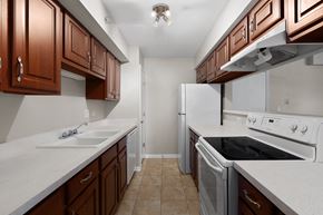 Arlington Heights apartment for rent - a kitchen with white appliances and wooden cabinets