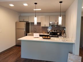 Auburn apartment for rent - a kitchen with a white counter top and a stainless steel refrigerator