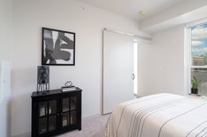 Minneapolis apartment for rent - a bedroom with a large bed and a door to a bathroom