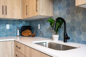 Minneapolis apartment for rent - a kitchen with blue tiles on the wall and a sink