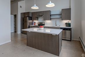 Minneapolis apartment for rent - A modern kitchen with a large island in the center.