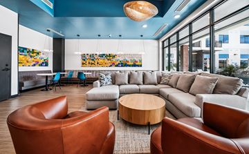 Phoenix apartment for rent - A living room with a brown leather chair and a grey sofa.