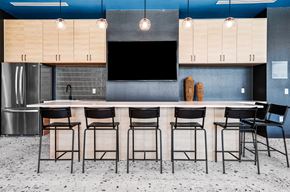 Phoenix apartment for rent - A kitchen with a bar area featuring a counter and chairs.