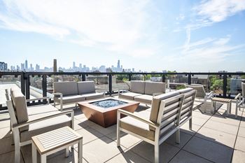 Rooftop with skyline views, grills, and fire pit