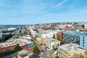 Seattle apartment for rent - an aerial view of the city of seattle with a blue sky and a body of water