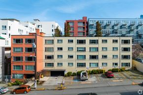 Seattle apartment for rent - south facade of the building with parking lot in front of it