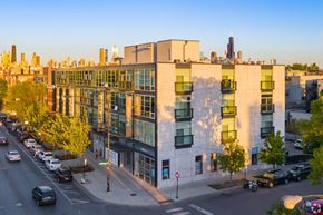 Chicago apartment for rent - an aerial view of a building with a city skyline in the background