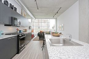 Chicago apartment for rent - a kitchen with granite counter tops and a sink and a window